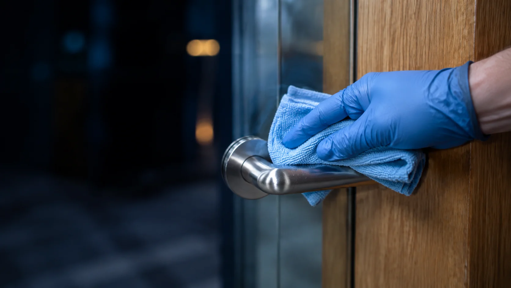 Illustrative close-up of cleaning an entrance handle
